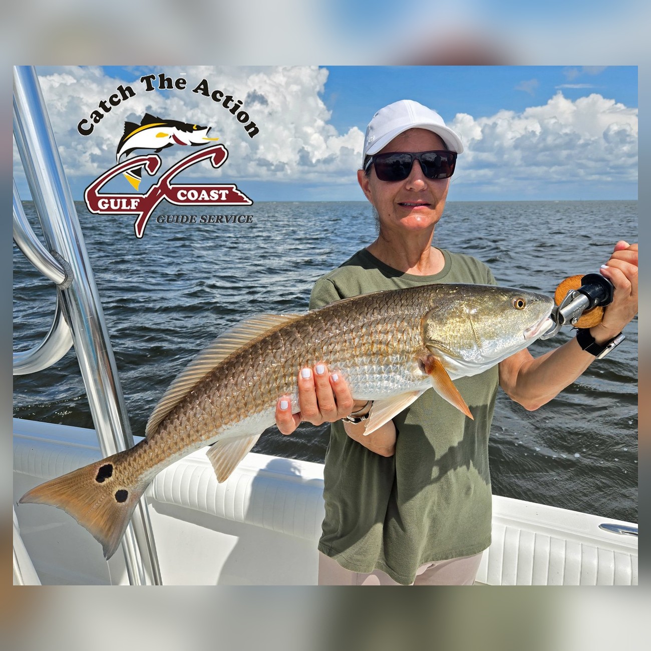 Angler holding a redfish aboard a Gulf Coast Guide Service charter
