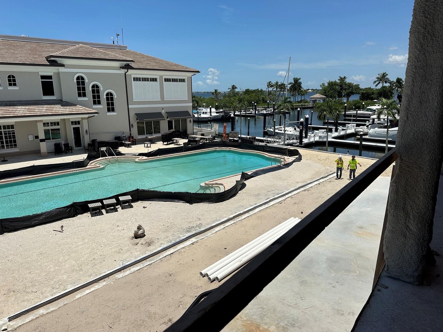 Clubhouse pool area with pavers being installed