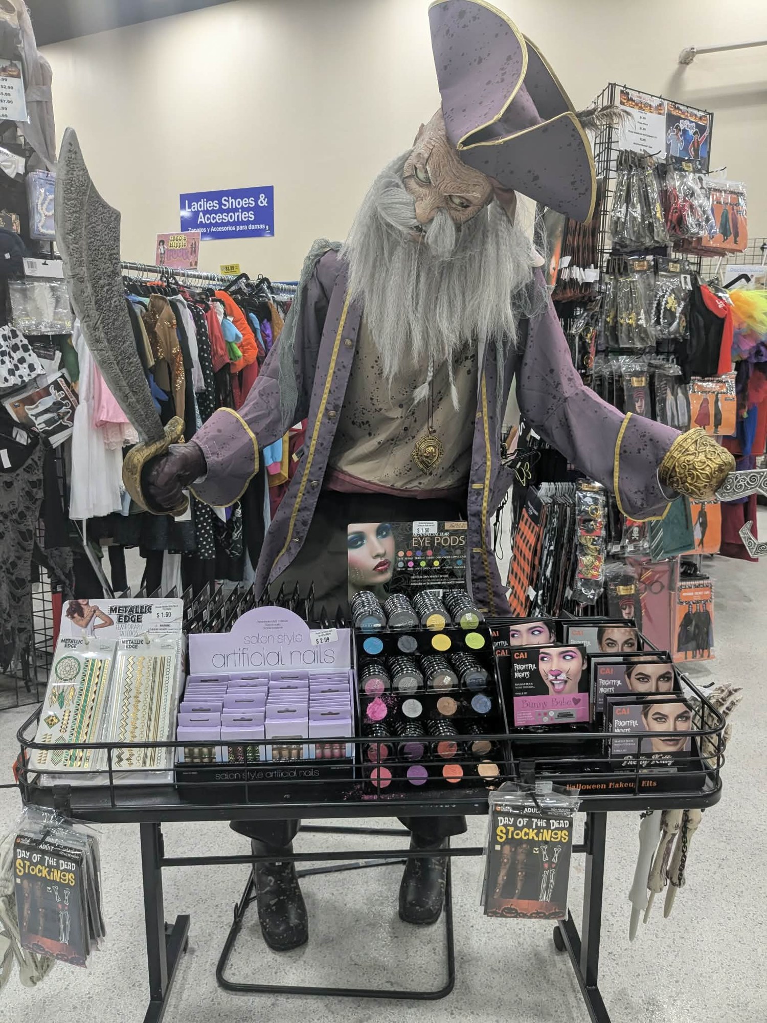 Pirate figure and Halloween makeup display at a Goodwill Boo-teek
