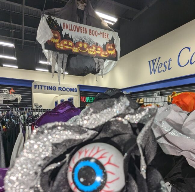 Halloween Boo-teek sign and costume racks inside a Goodwill Southwest Florida store